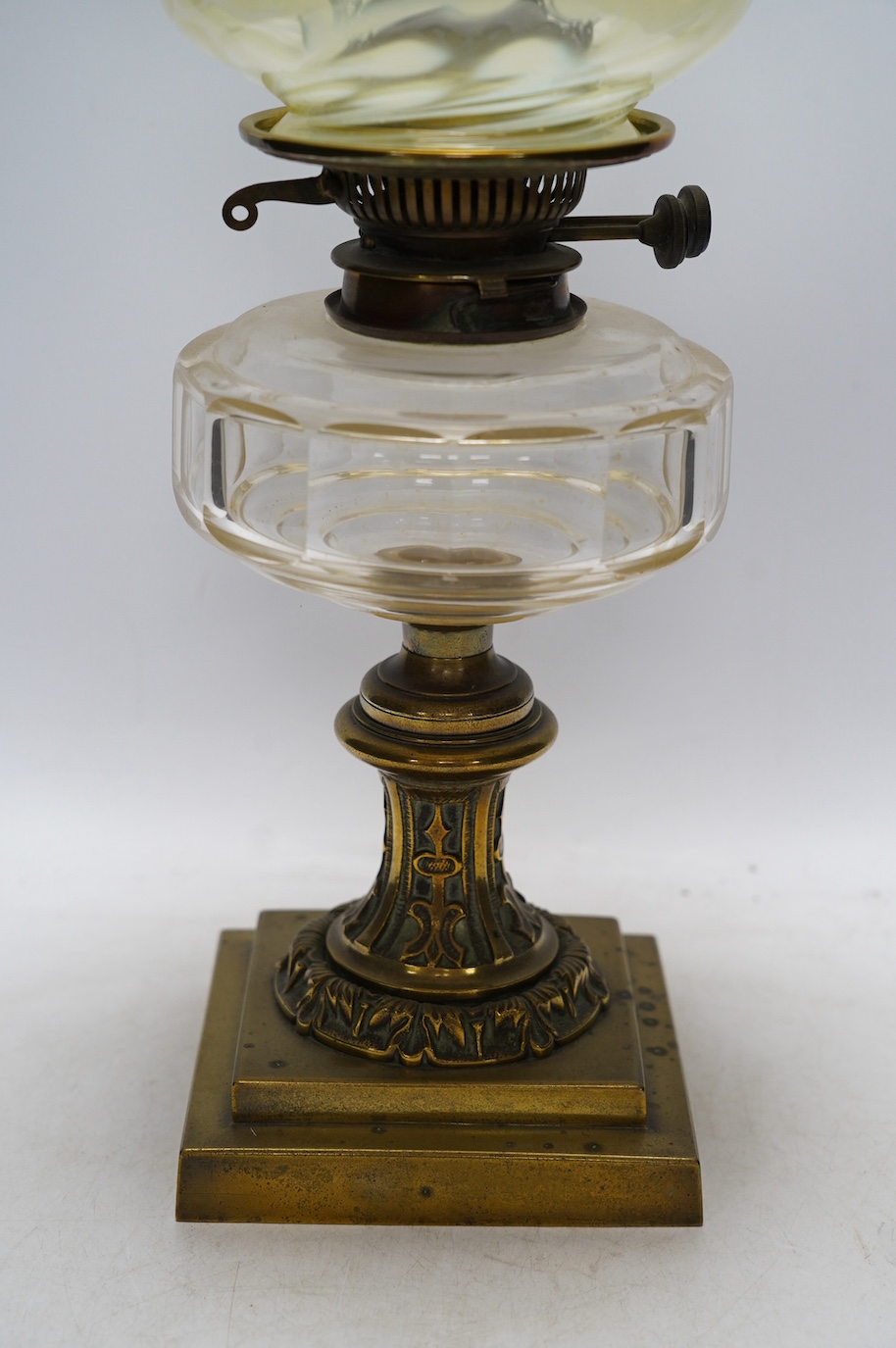 A brass oil lamp with glass reservoir and vaseline glass fluted shade, 48cm high. Condition - good